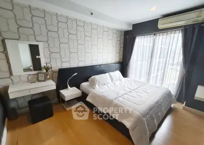 Modern bedroom with stylish decor and large window for natural light