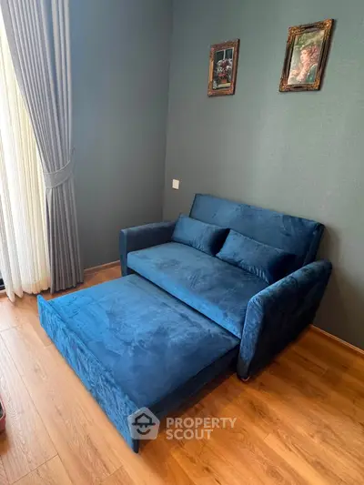 Cozy living room with blue velvet sofa bed and elegant decor