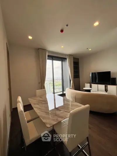 Modern living room with dining area and stunning city view from large windows.