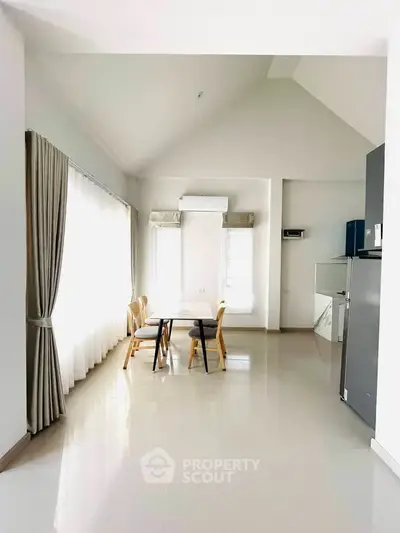 Spacious dining area with natural light and modern furnishings