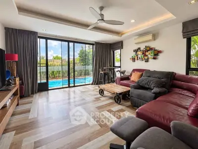 Spacious living room with pool view and modern decor