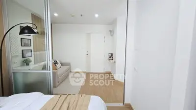 Modern minimalist bedroom with sliding glass doors and cozy decor.