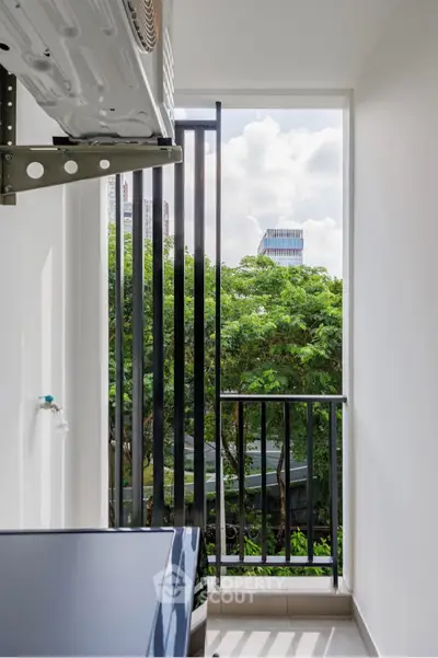 Modern balcony with lush green view and cityscape in the background.