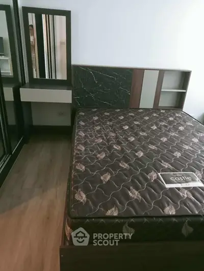 Modern bedroom with stylish bed and vanity in a cozy apartment setting.