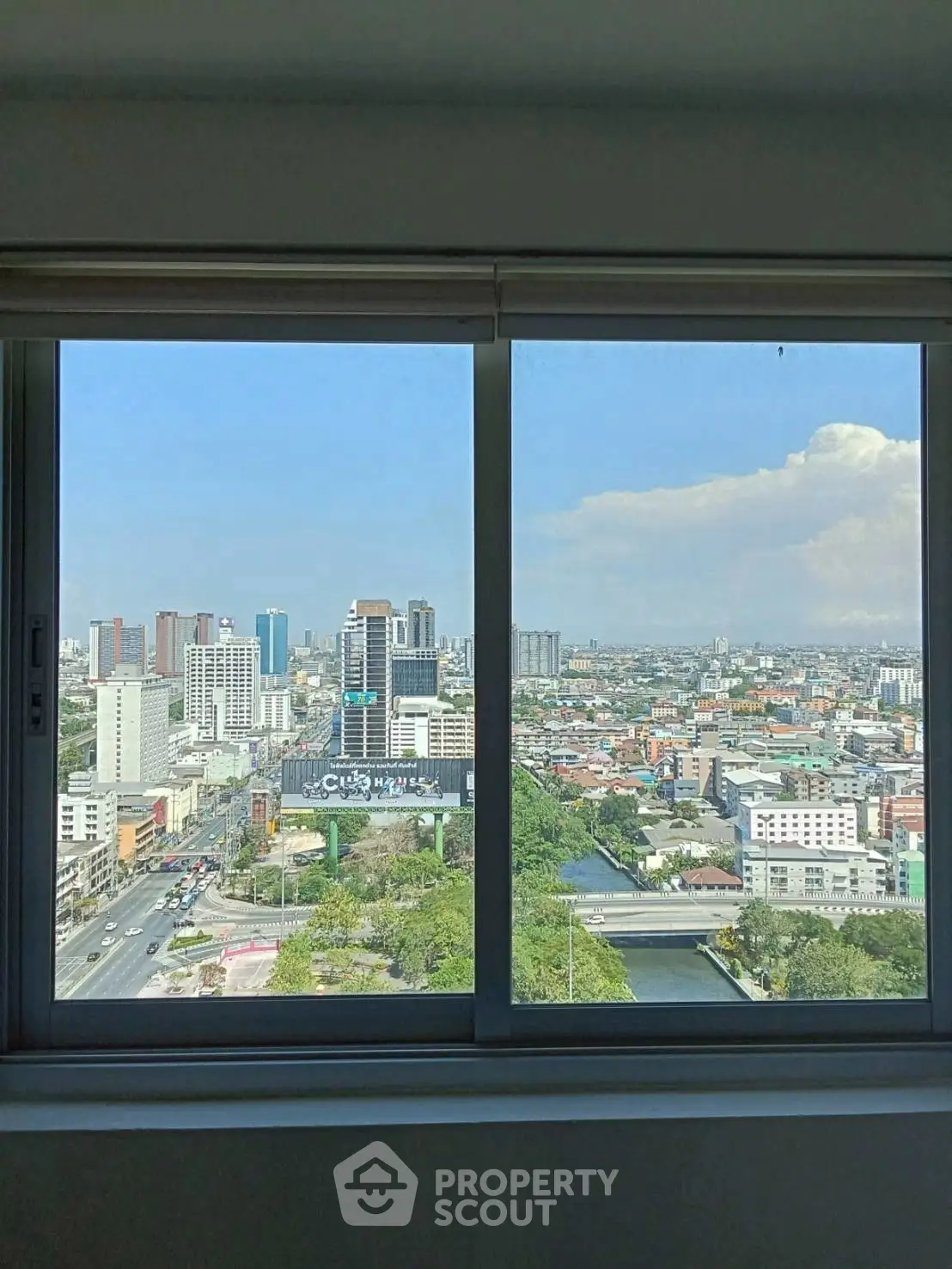 Stunning cityscape view from a high-rise apartment window, showcasing urban living at its finest.