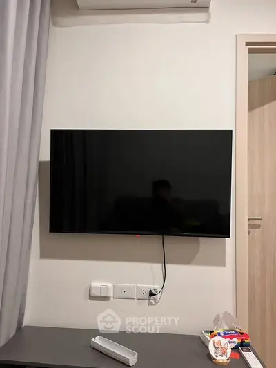 Modern living room with wall-mounted TV and stylish decor