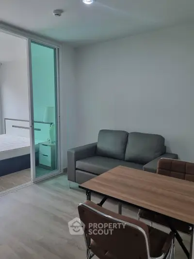Modern apartment interior with cozy living area and adjacent bedroom