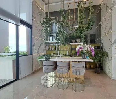 Luxurious modern kitchen with marble accents and elegant bar seating