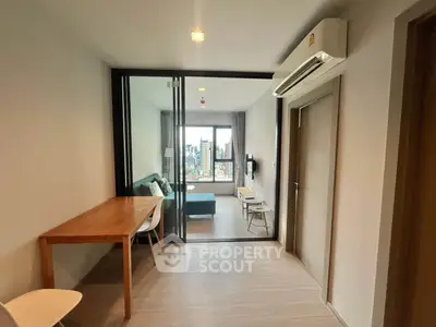 Modern apartment interior with open layout and city view, featuring a cozy living area and dining space.