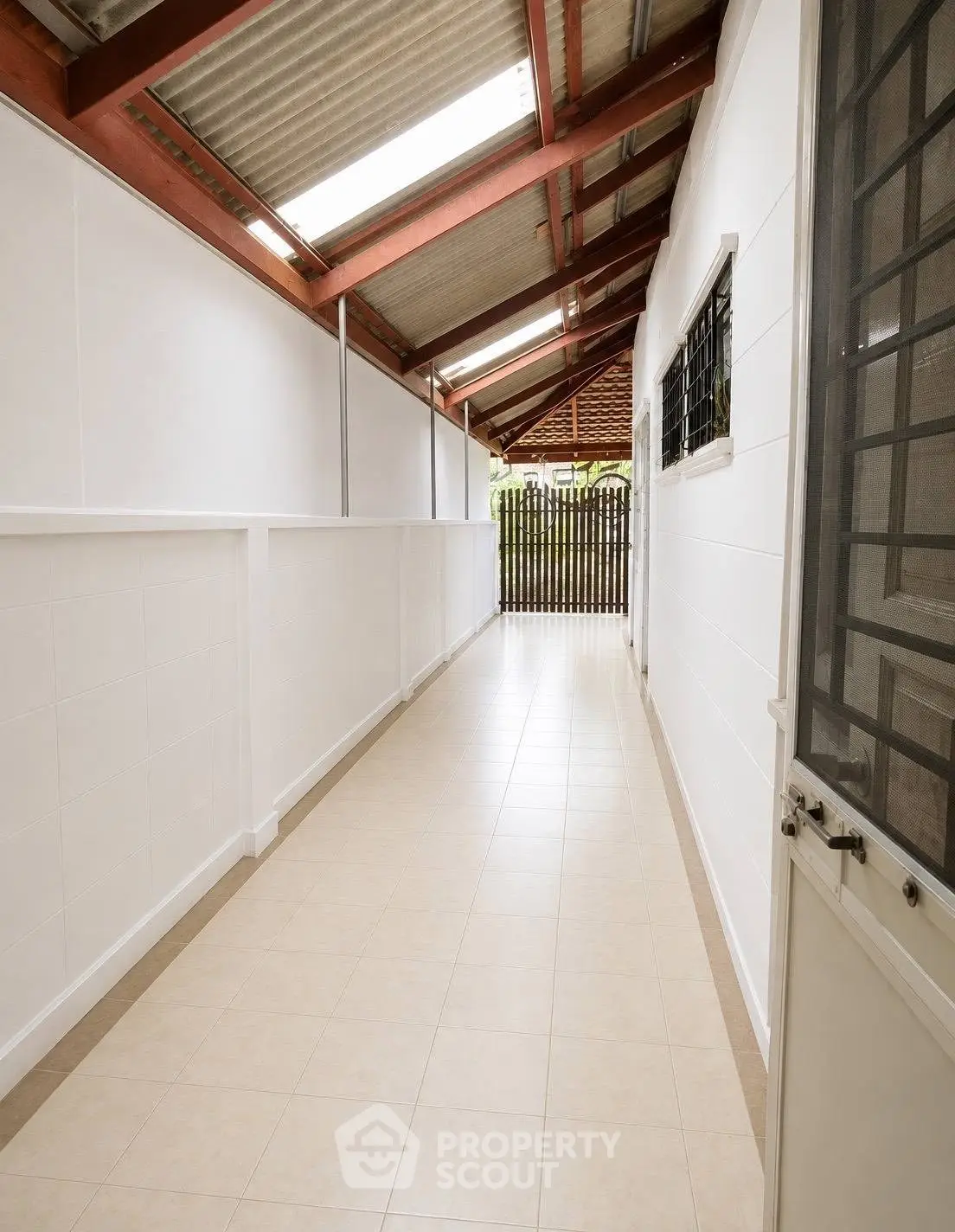Bright corridor with tiled flooring and skylight in modern property