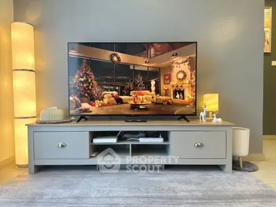 Stylish living room with modern TV stand and cozy decor, perfect for holiday gatherings.