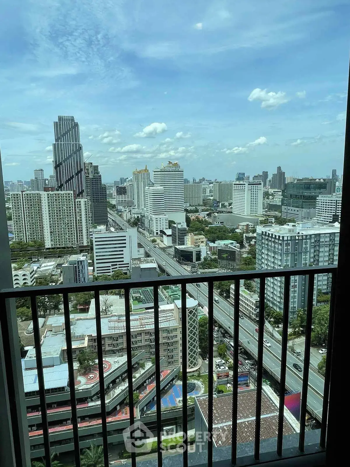 Stunning cityscape view from high-rise balcony in urban setting