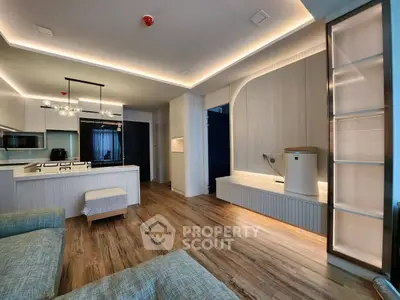 Modern living room with open kitchen and stylish lighting