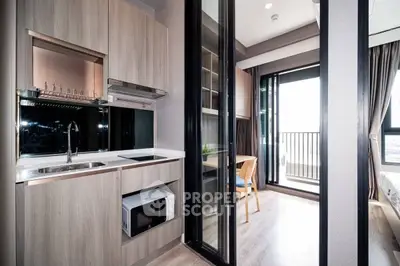 Modern apartment kitchen with open layout and balcony view