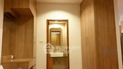 Modern bathroom with wooden cabinetry and sleek sink design