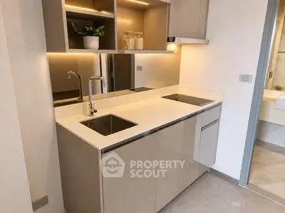 Modern kitchen with sleek cabinetry and under-cabinet lighting in a stylish apartment.