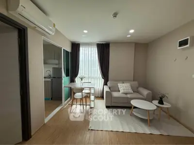 Modern living room with cozy sofa, stylish coffee table, and natural light from large window.