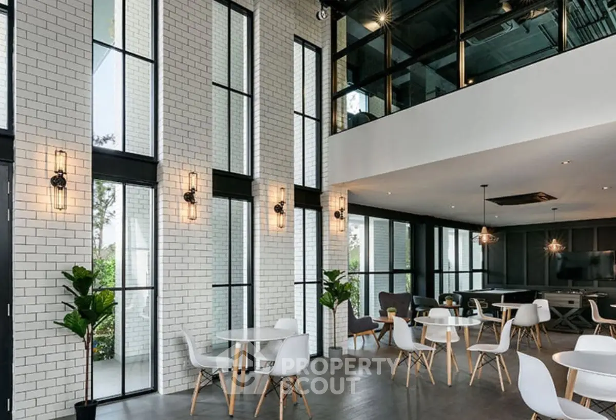 Modern co-working space with high ceilings and stylish furniture