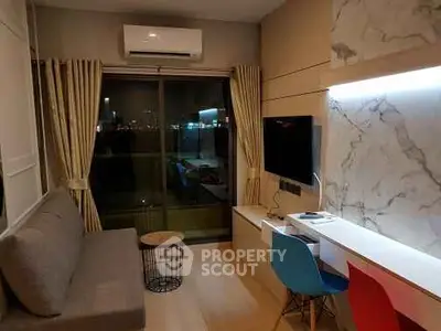 Modern living room with stylish decor and city view, featuring a cozy sofa and wall-mounted TV.