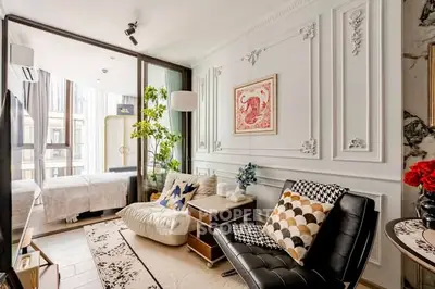 Luxurious living room with elegant decor and large windows in modern apartment.