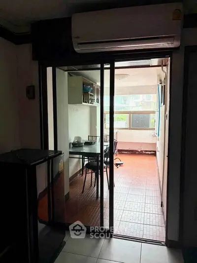 Cozy dining area with sliding glass doors and air conditioning, perfect for intimate meals.