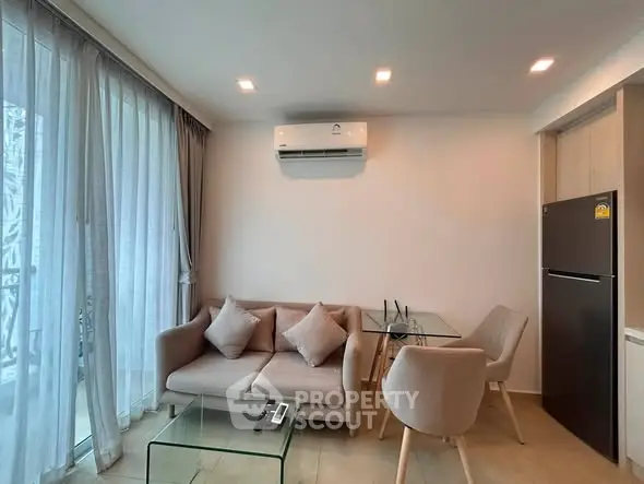 Modern living room with air conditioning, glass table, and cozy sofa in a stylish apartment.
