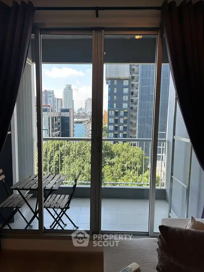 Modern apartment balcony with city view and cozy seating area.