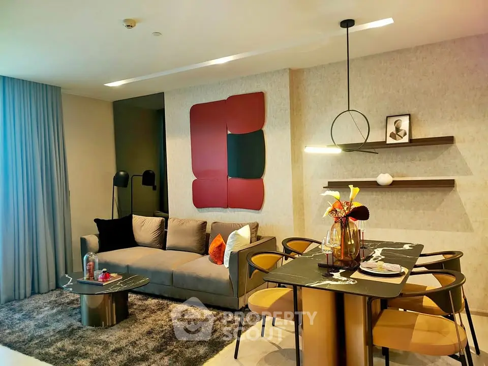 Modern living room with stylish decor and dining area, featuring contemporary furniture and elegant lighting.