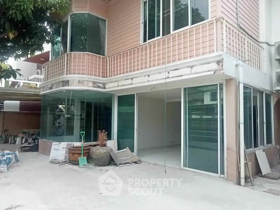 Spacious modern building exterior with large glass windows and open patio area.