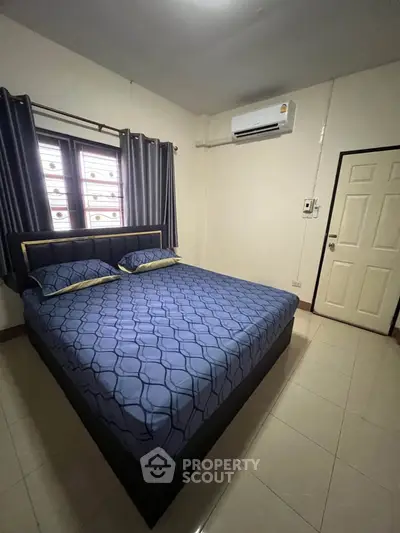 Cozy bedroom with modern decor and air conditioning, perfect for restful nights.