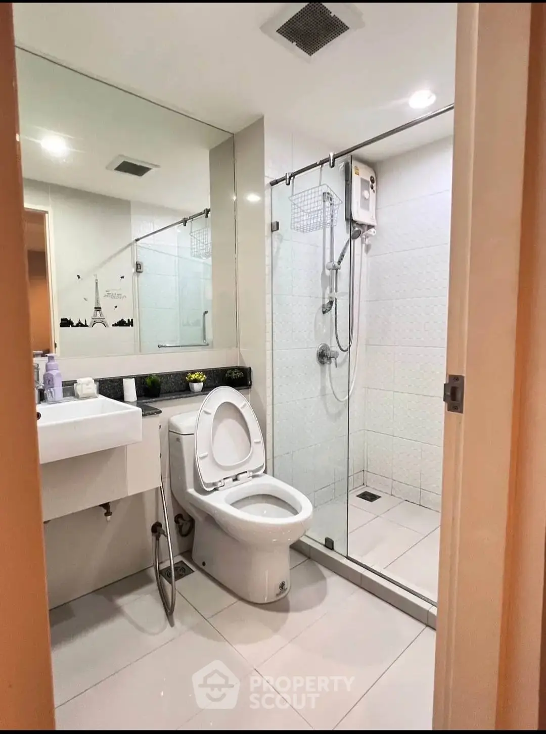 Modern bathroom with glass shower and sleek fixtures in a contemporary home.