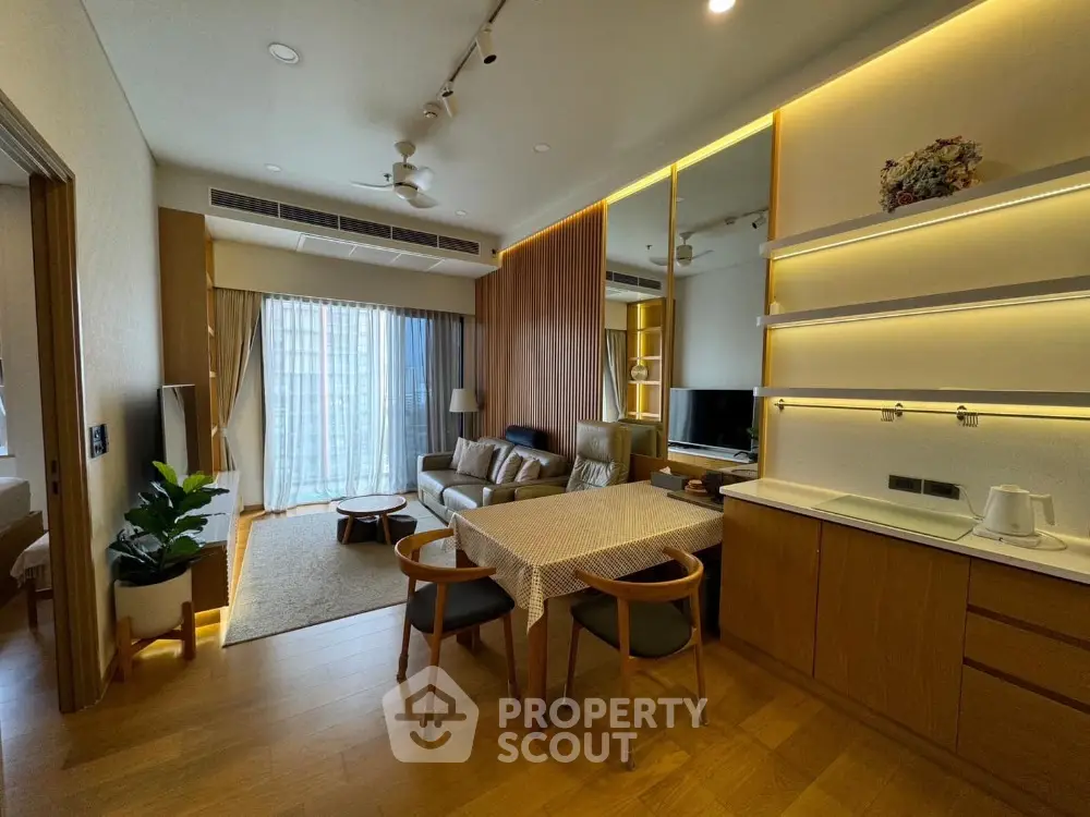 Modern living room with open kitchen and stylish decor in a cozy apartment.