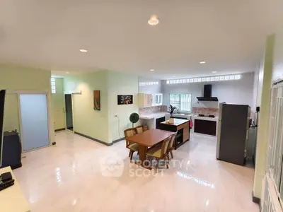 Spacious open-plan kitchen and dining area with modern appliances and stylish decor.