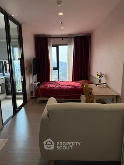 Modern studio apartment with city view, featuring cozy living area and stylish decor.