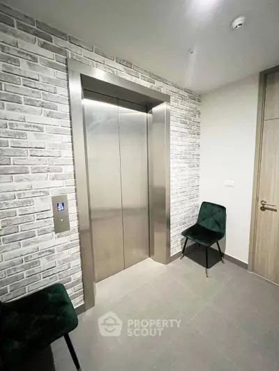 Modern elevator lobby with stylish brick wall and seating area