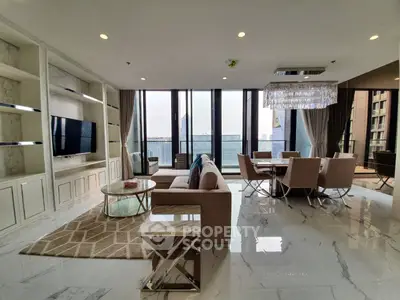 Luxurious modern living room with elegant decor and large windows offering stunning city views.