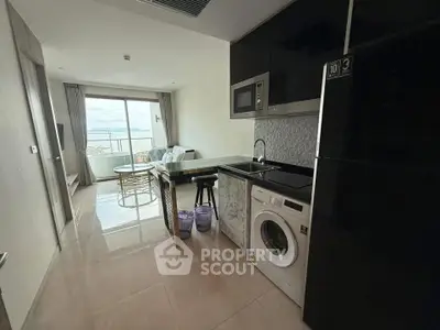 Modern open-layout kitchen with ocean view balcony in a stylish apartment