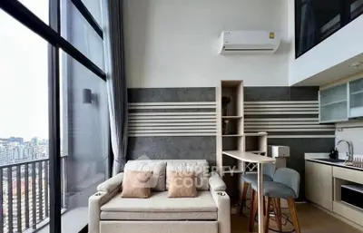 Modern loft apartment with city view, featuring cozy living area and stylish kitchen.