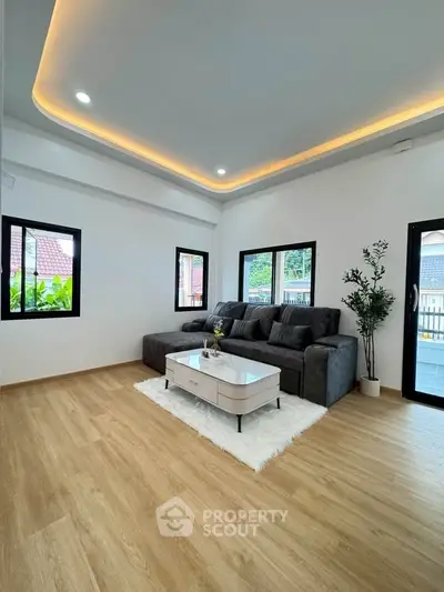 Spacious modern living room with elegant lighting and cozy seating area.