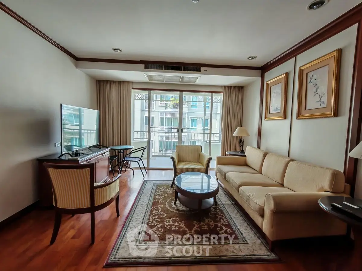 Elegant living room with cozy sofa, stylish decor, and large window for natural light.