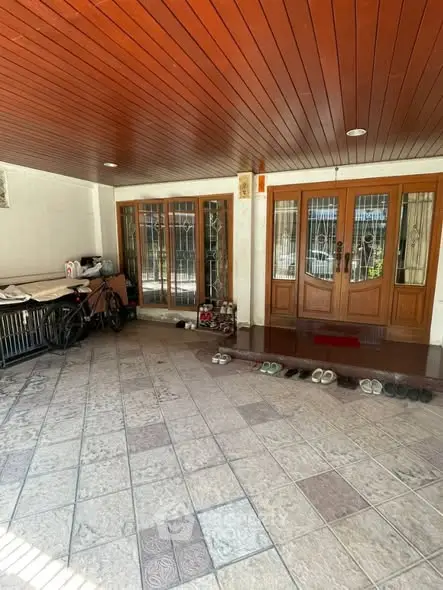 Spacious entrance with tiled flooring and wooden doors, perfect for welcoming guests.