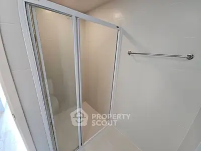 Modern bathroom with sleek shower enclosure and towel rack