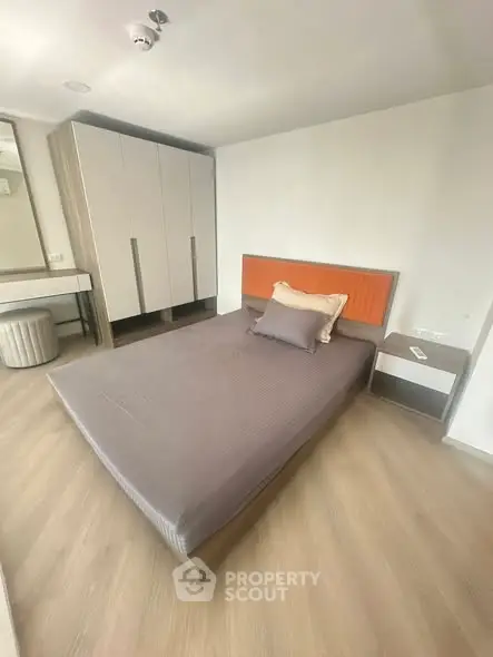 Modern bedroom with stylish furniture and ample storage space