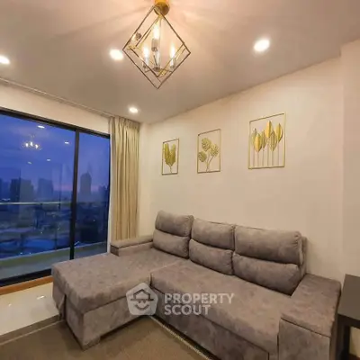 Modern living room with stylish decor and city view, featuring a plush sectional sofa and elegant lighting.