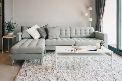 Modern living room with stylish gray sectional sofa and elegant decor