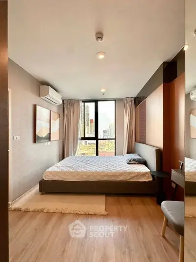 Modern bedroom with city view, stylish decor, and natural light