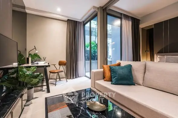 Modern living room with stylish decor and large windows in a luxury apartment.