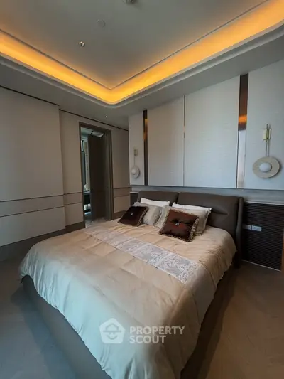 Luxurious bedroom with modern decor and ambient lighting, featuring a plush bed and elegant wall accents.