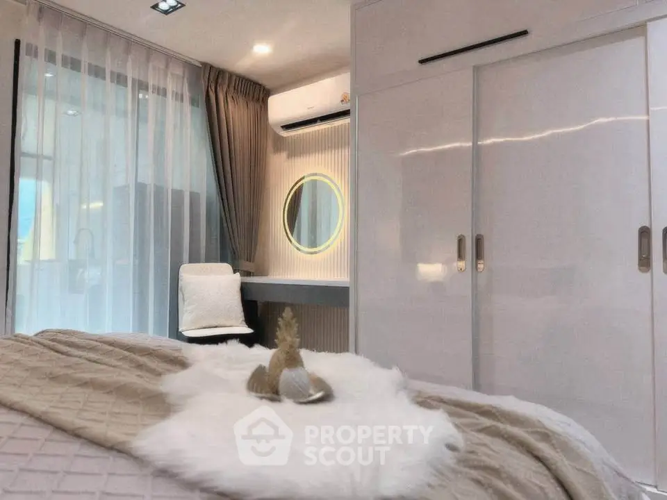 Luxurious bedroom with modern decor, featuring a stylish vanity and ample closet space.