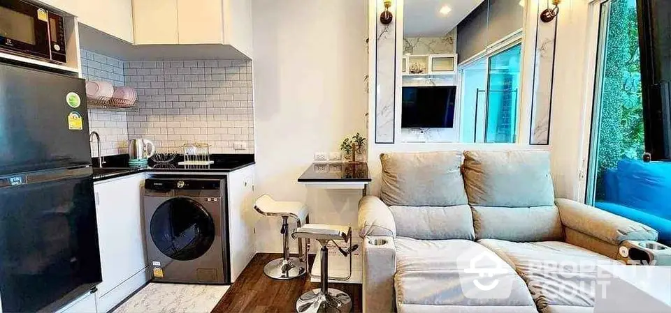 Modern compact living room with integrated kitchen and washing machine